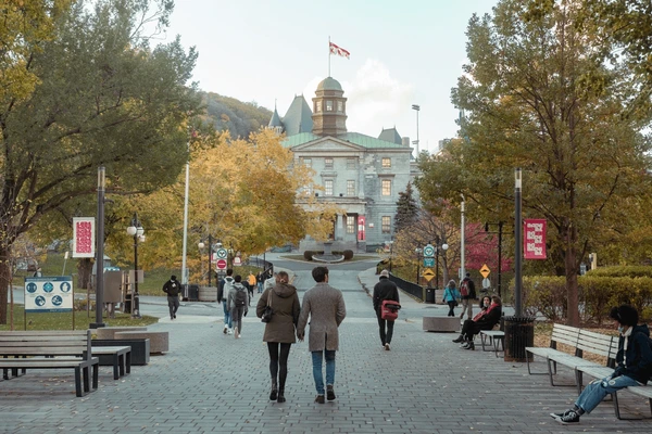 A diverse group of university students walking through a Canadian college campus during the fall season, representing Canada’s international education appeal.