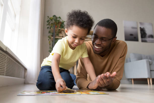 Parent assisting child in problem-solving activities as part of a children's education plan.