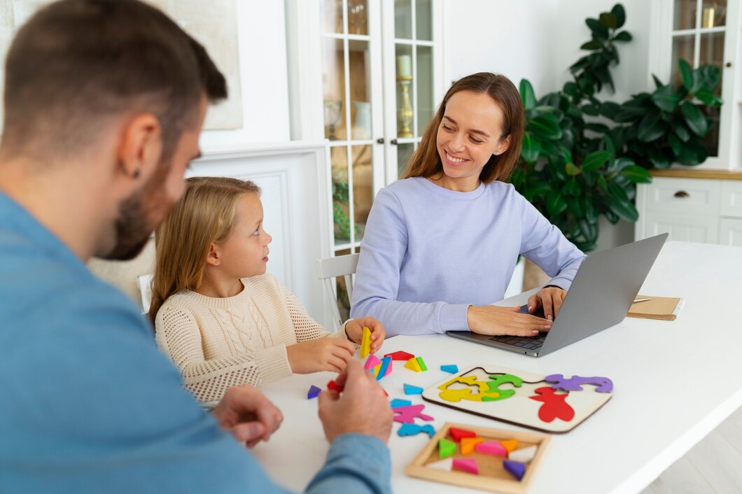 A family sitting together at a table with colorful puzzle pieces and a laptop, discussing ideas and activities as part of building a career plan for the child’s future.