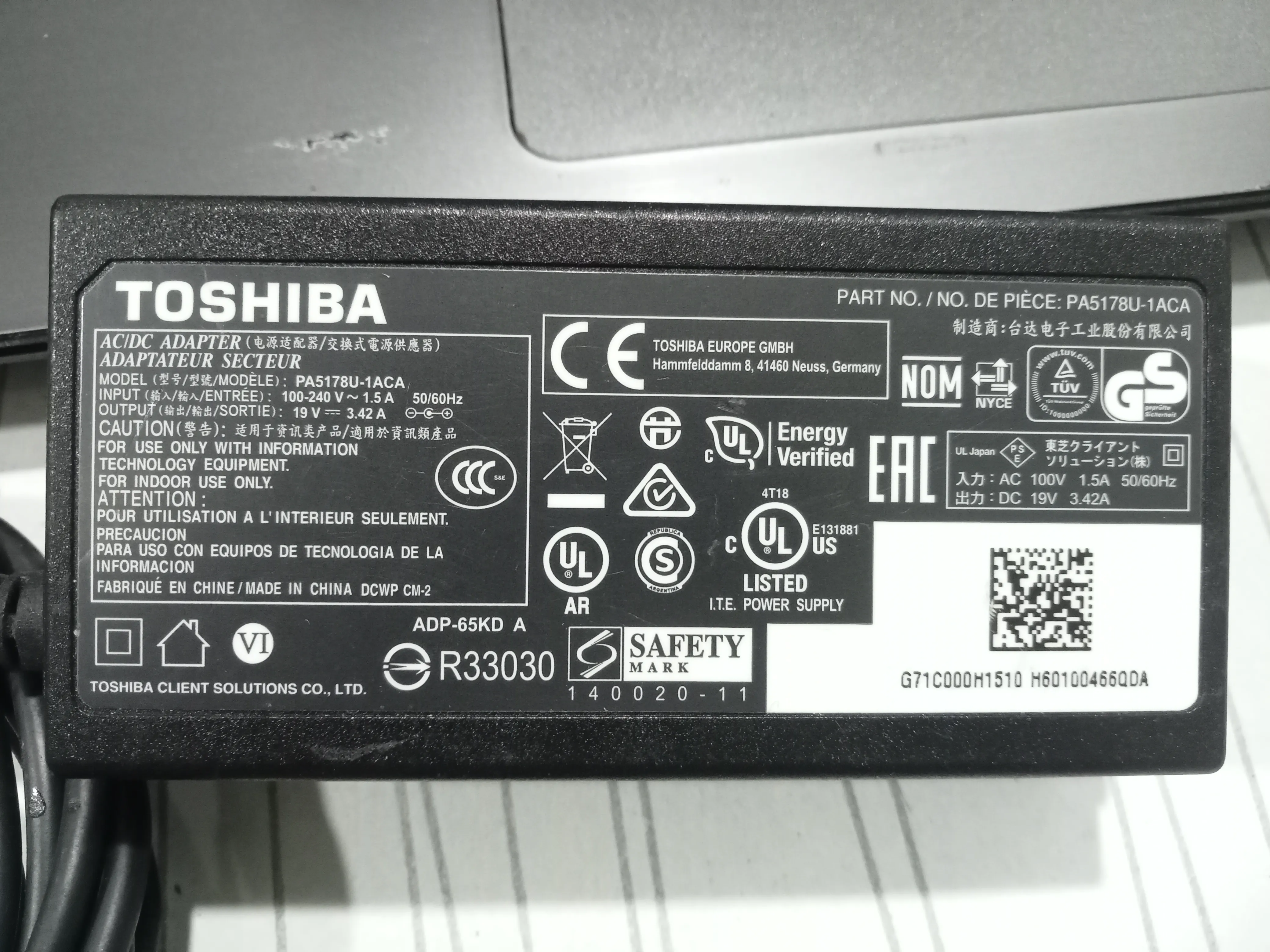 Top and bottom perspectives of the authentic matte black 19V 3.42A Toshiba power supply block.