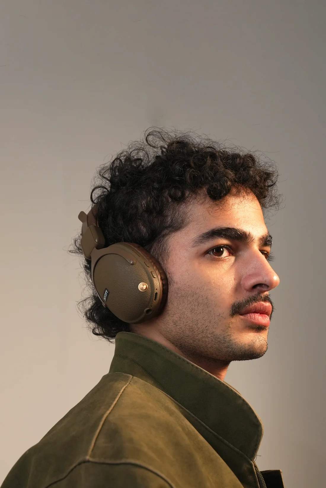 Close-up view of earcup controls on Boost Note wireless bt headphones in Brown