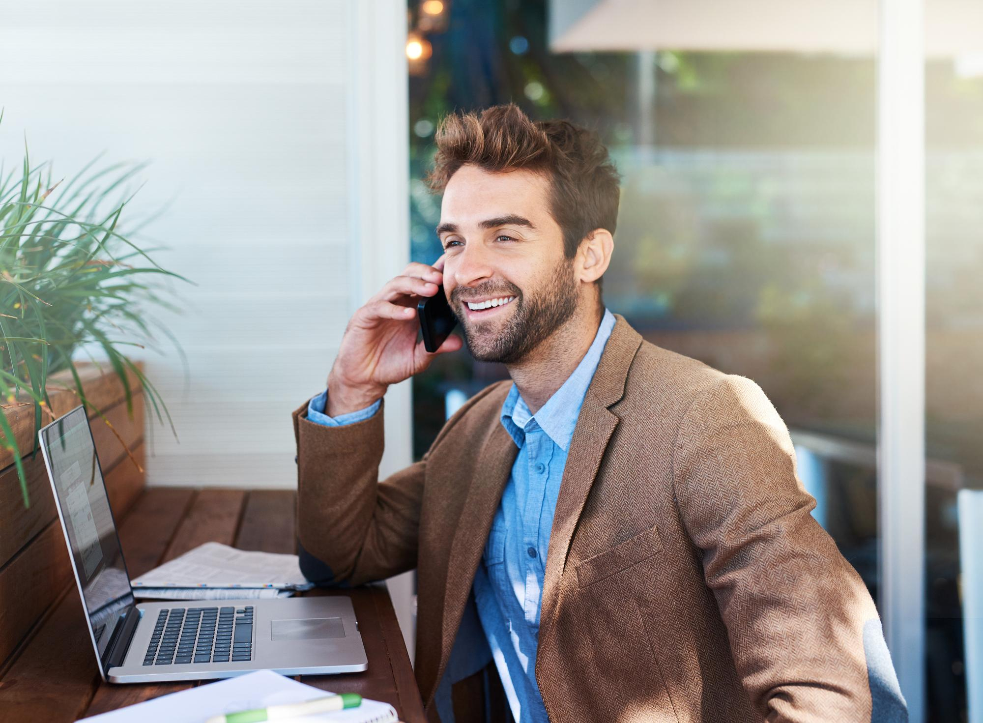 Man talking on the phone at his desk