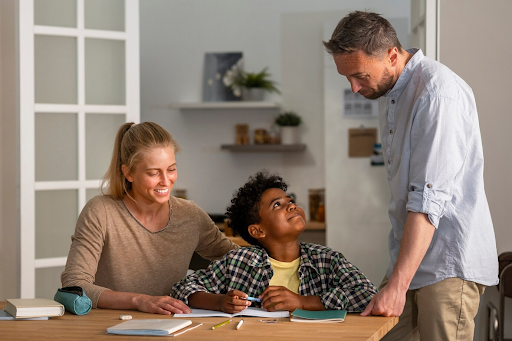 A family sitting together at a dining table, discussing career plans with their teenage child.